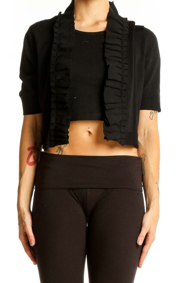 Front view of black ruffled cropped cardigan from The Limited