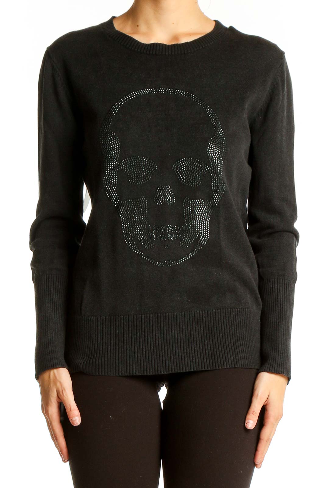 Front view of black knit sweater with studded skull design