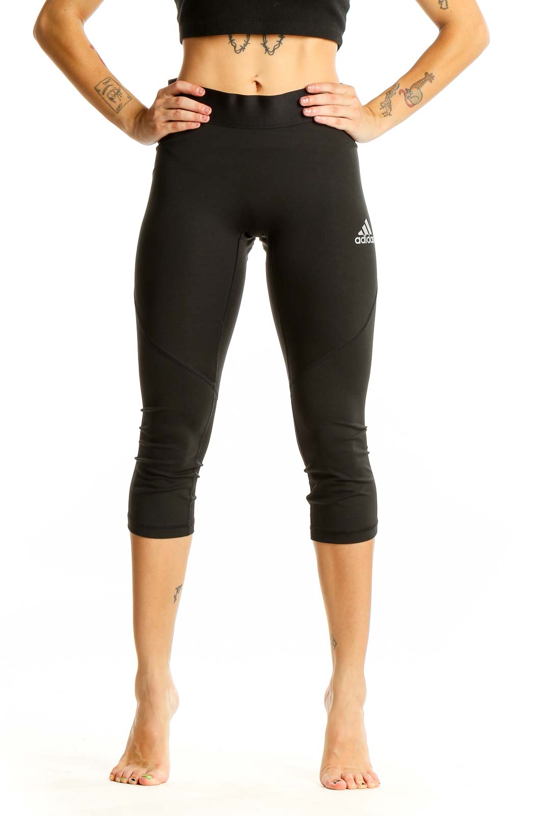 Front view of black Adidas capri leggings on model