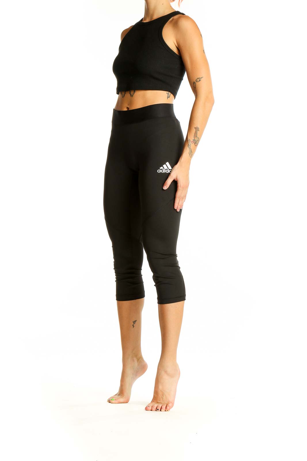 Front view of black Adidas capri leggings on model