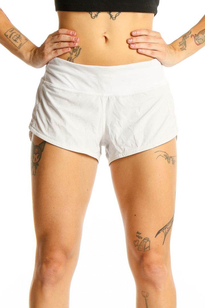 Front view of white Lululemon athletic shorts on model