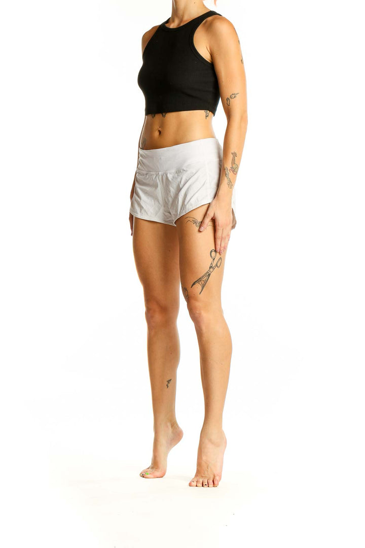 Front view of white Lululemon athletic shorts on model