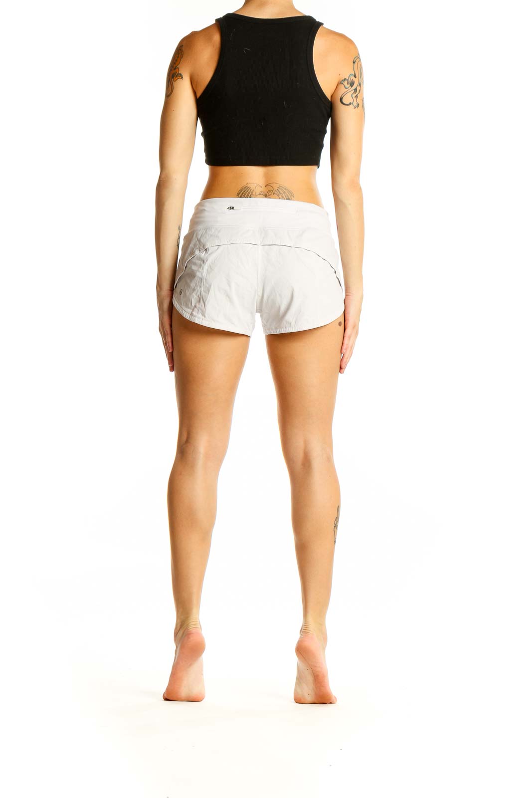 Back view of white Lululemon athletic shorts on model