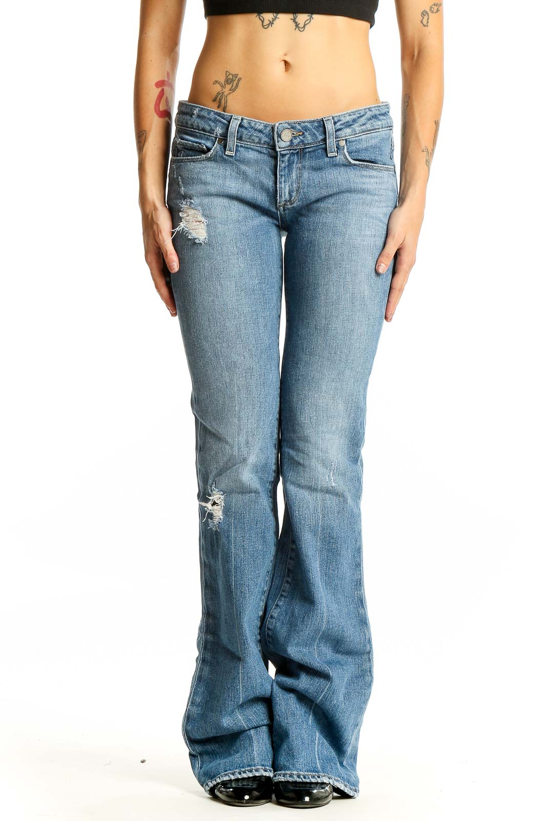 Front view of Paige light blue distressed flare jeans on model