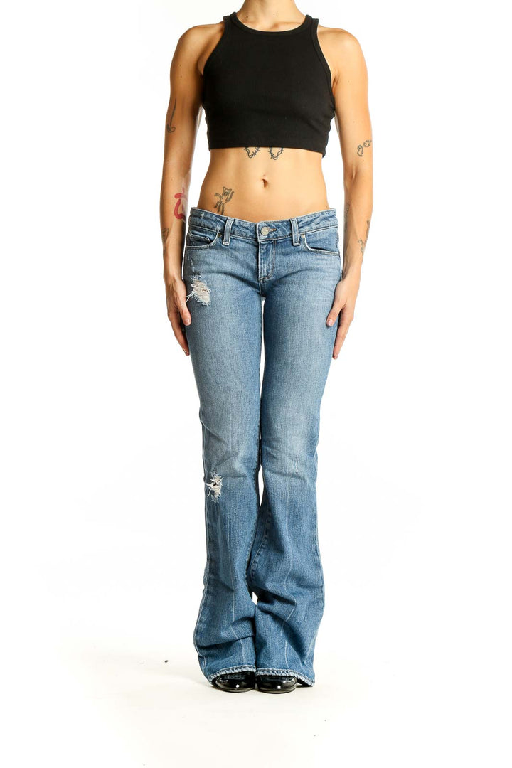 Front view of Paige light blue distressed flare jeans on model