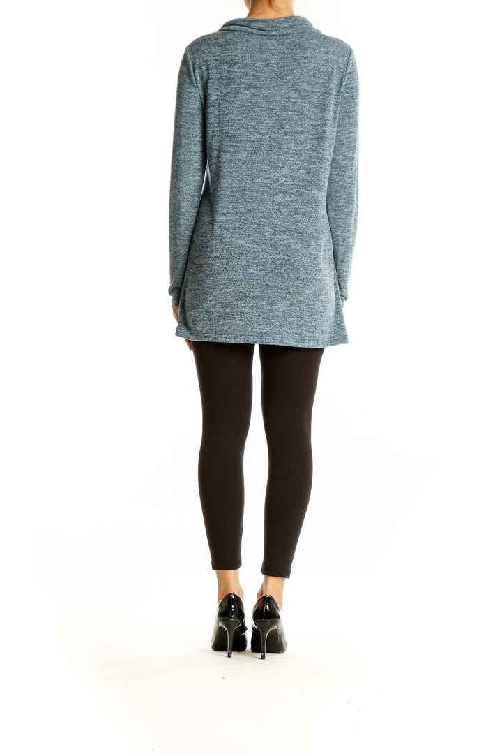 Side view of woman wearing SilkRoll heathered blue zip-neck tunic sweater with black leggings