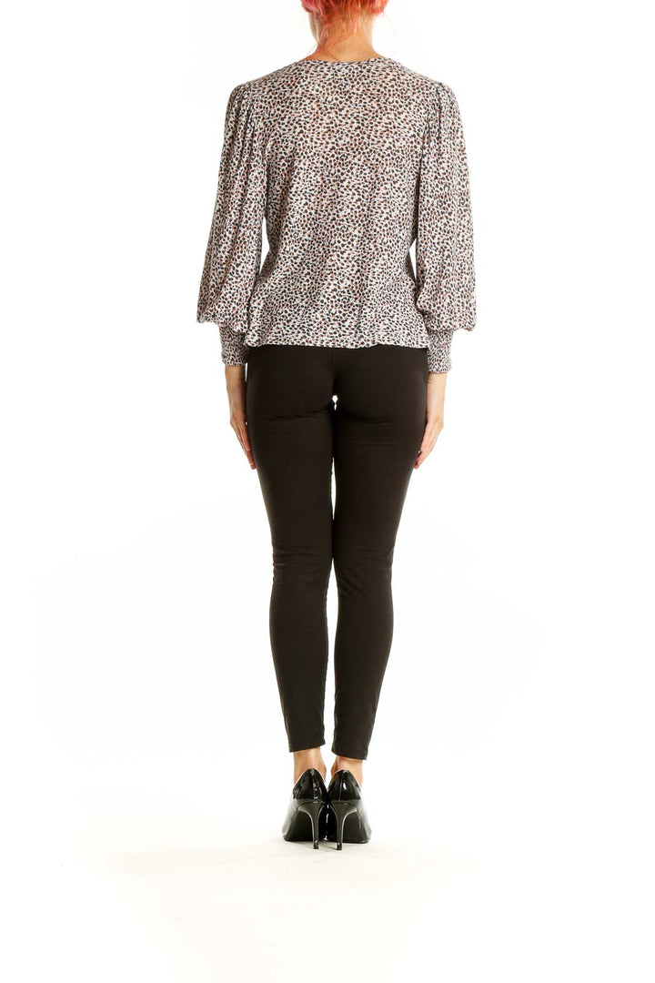 Back view of Nation LTD beige leopard print top showing relaxed fit