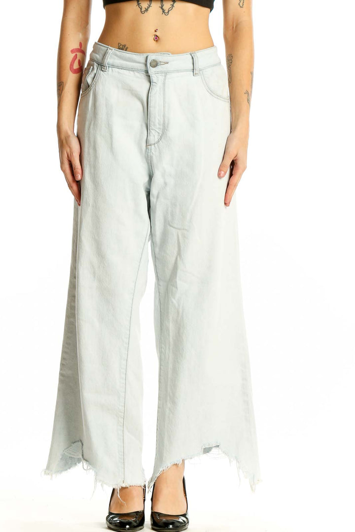 Front view of DL1961 light blue wide-leg jeans with distressed hem