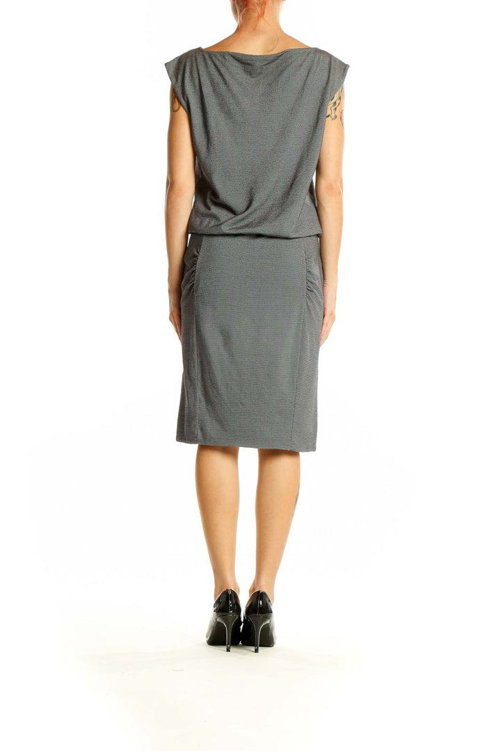 Side view of gray sleeveless blouson dress from Athleta showing ruched detailing