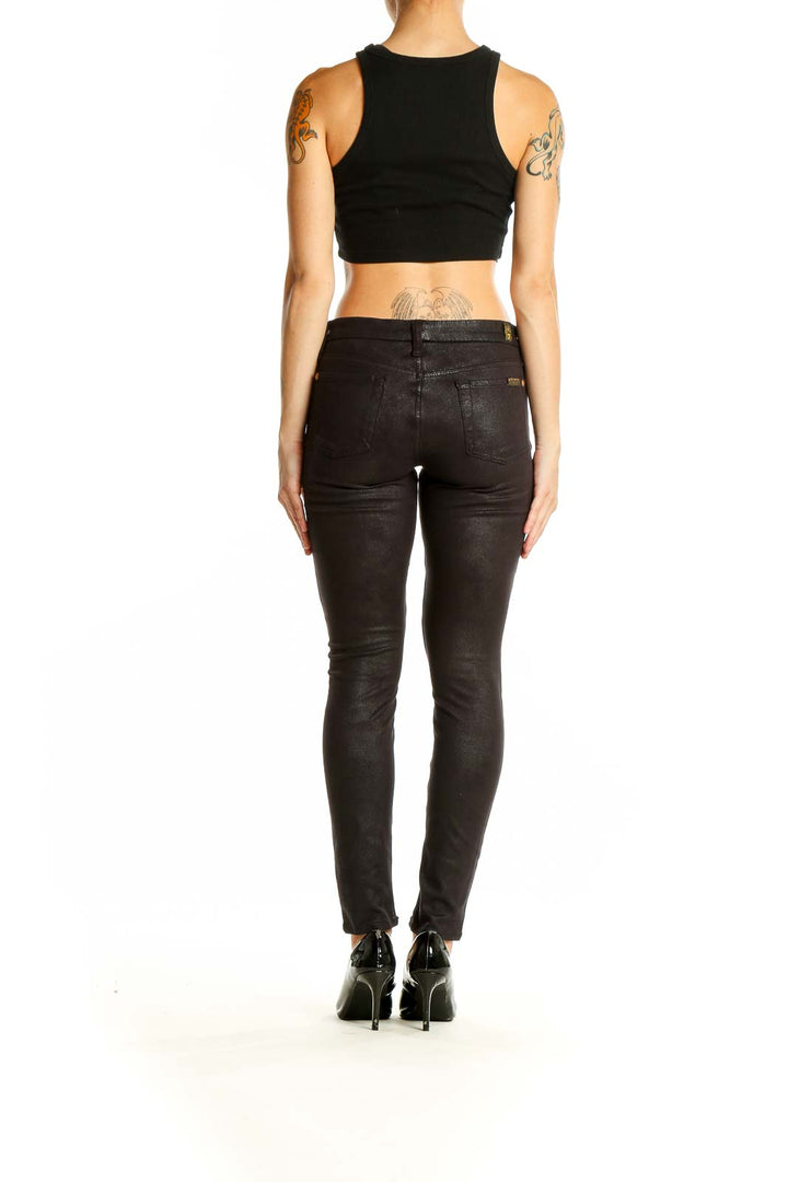 Back view of 7 For All Mankind black skinny pants on model