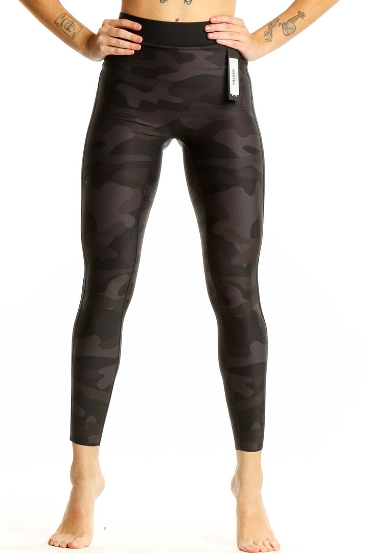 Front view of Ultracor black camo high-waist leggings on model