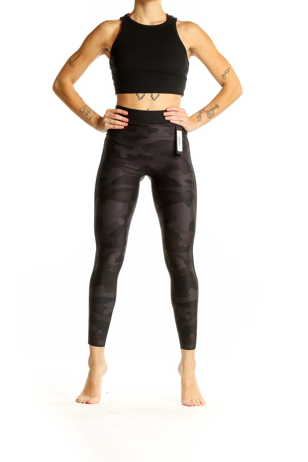 Front view of Ultracor black camo high-waist leggings on model