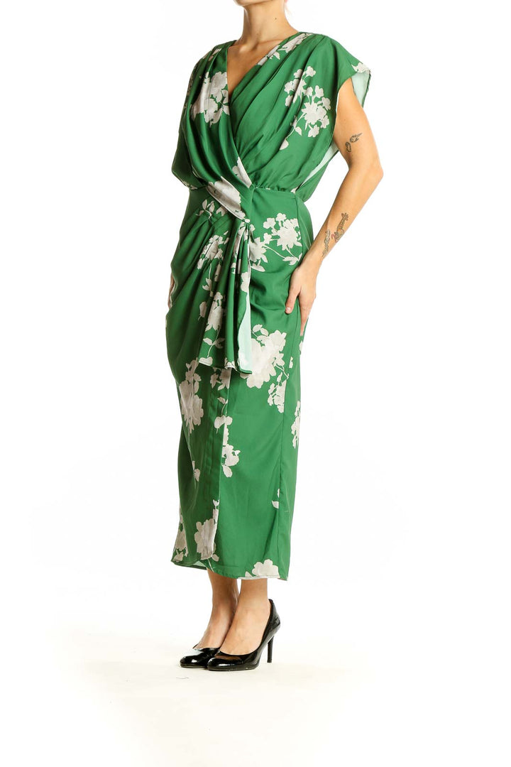 Front view of green floral wrap midi dress by Wayward Fancies