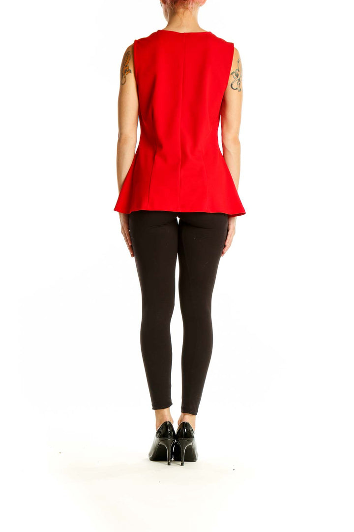 Side view of Ann Taylor red sleeveless peplum top showing silhouette