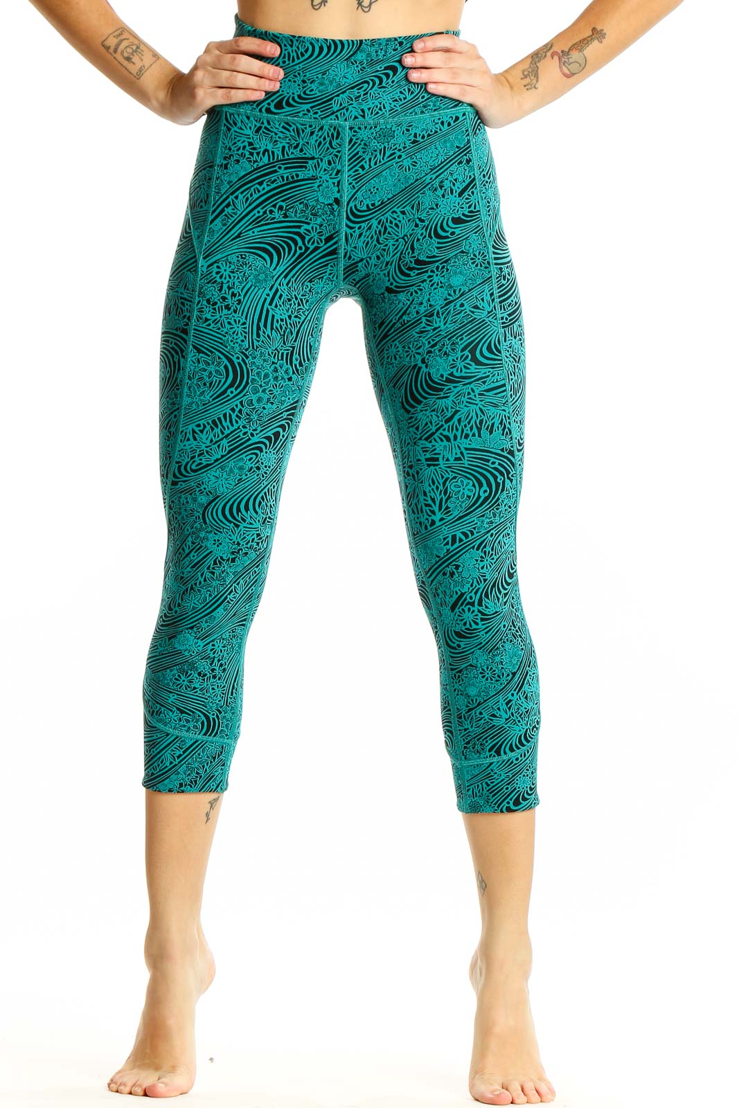 Front view of teal Lululemon capri leggings with black swirl pattern