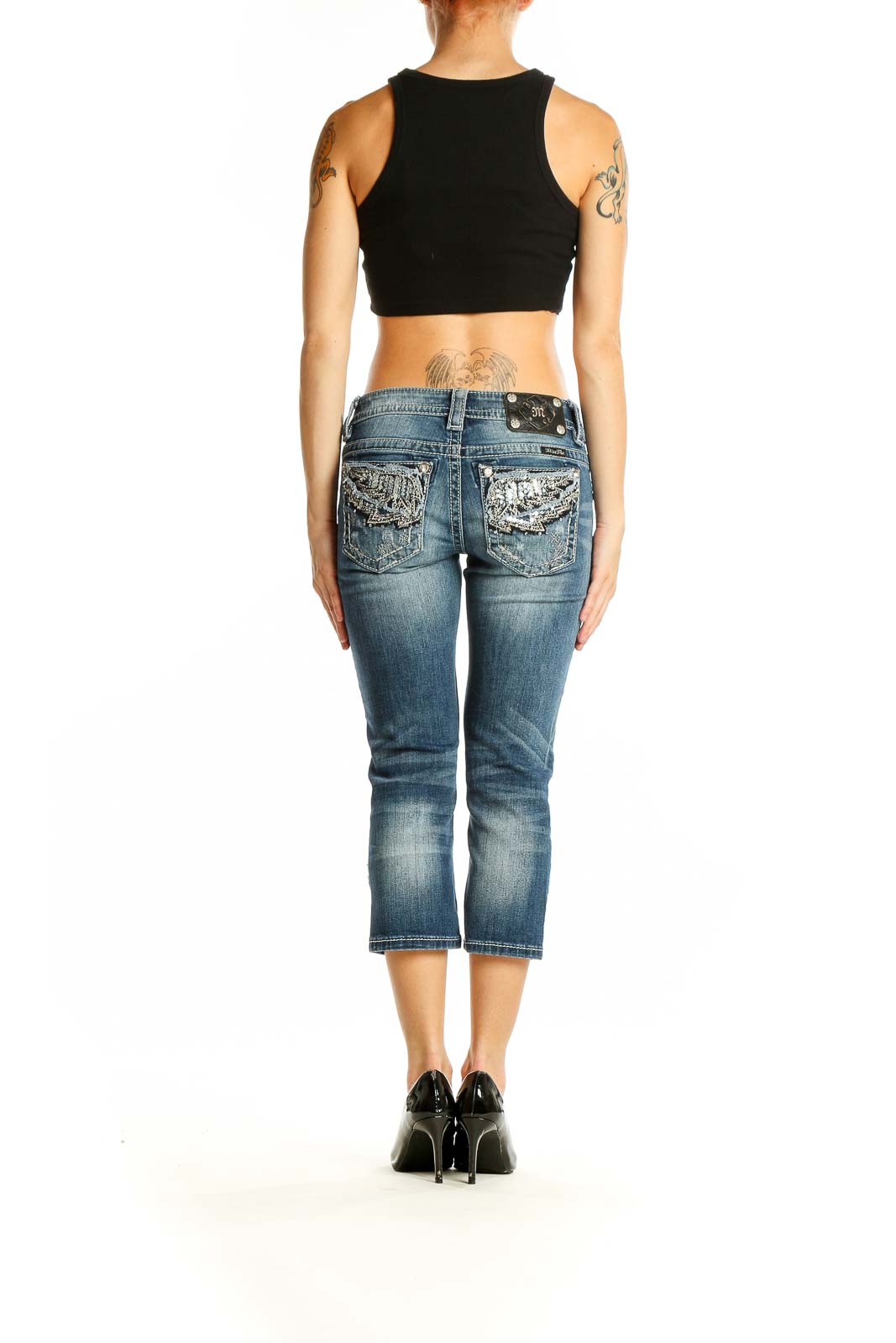 Back view of Miss Me blue faded cropped denim jeans on model