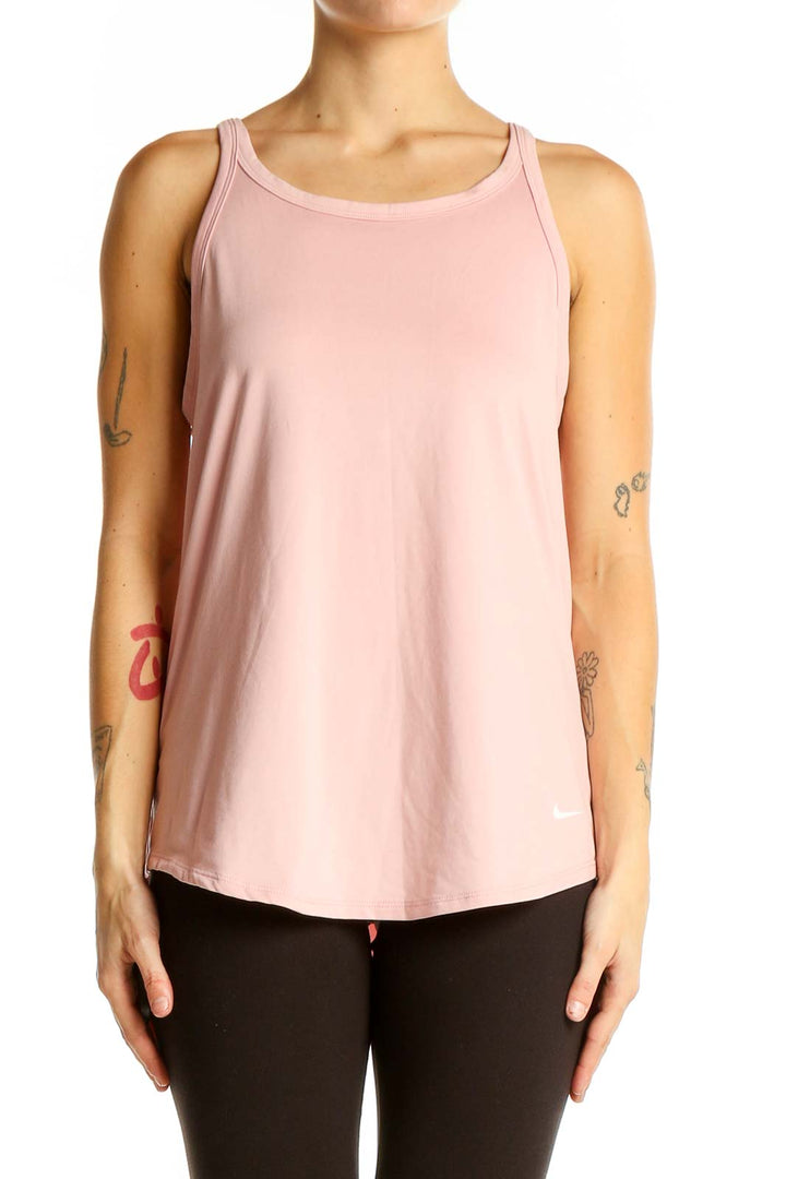 Front view of pink Nike athletic tank top on model