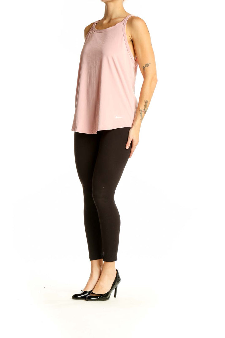 Front view of pink Nike athletic tank top on model