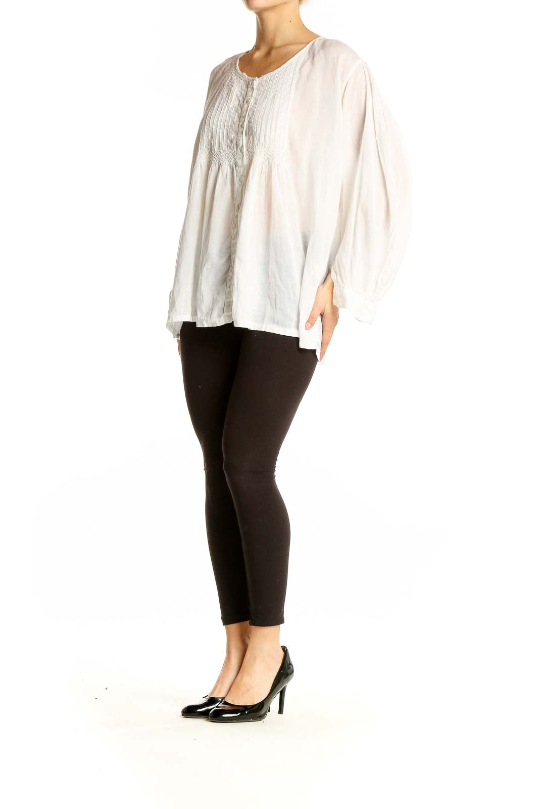 Front view of white pintuck blouse with flowy silhouette