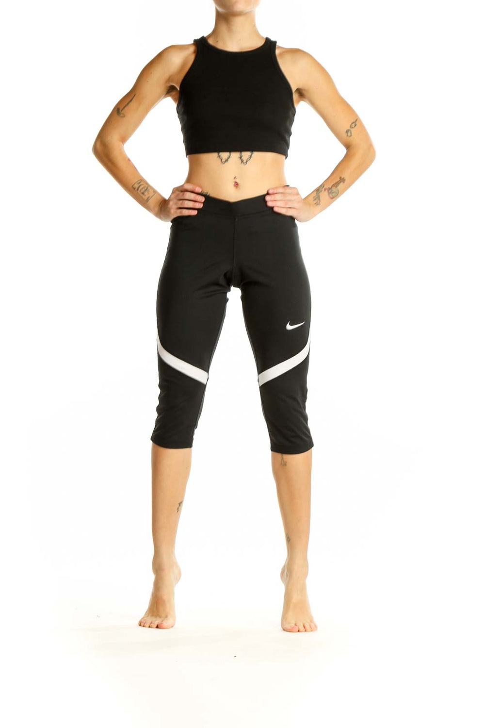 Front view of black Nike capri leggings with white stripe