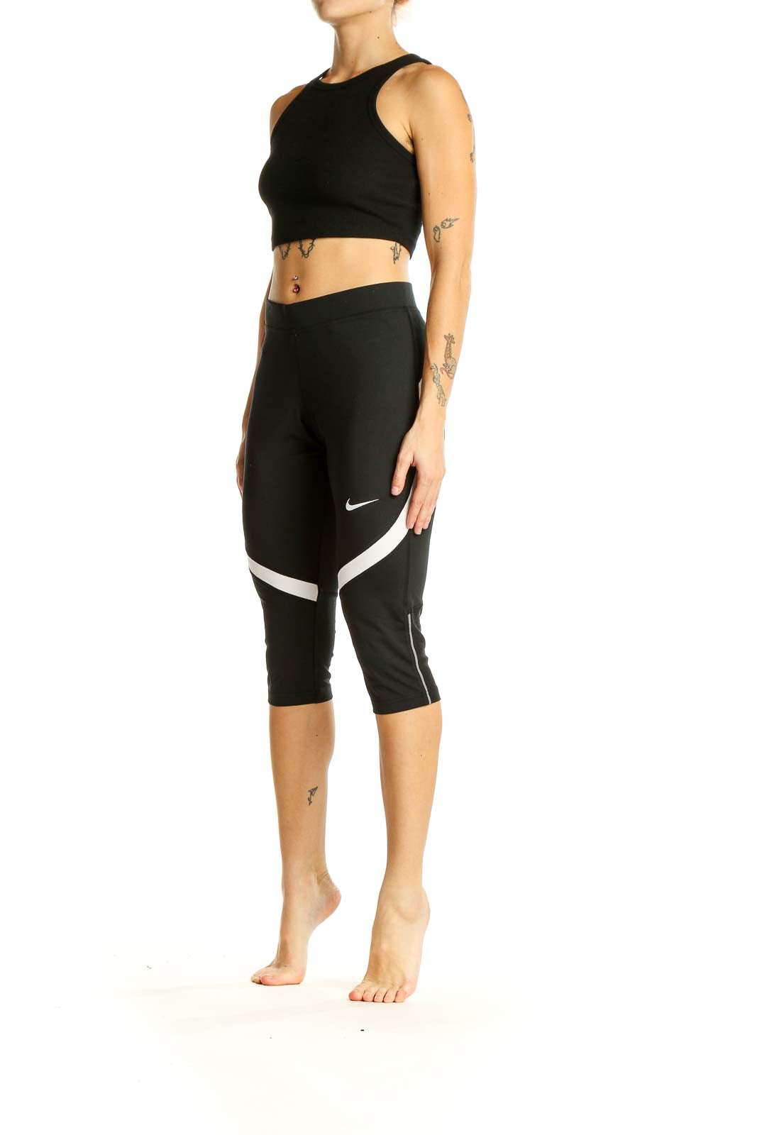 Front view of black Nike capri leggings with white stripe