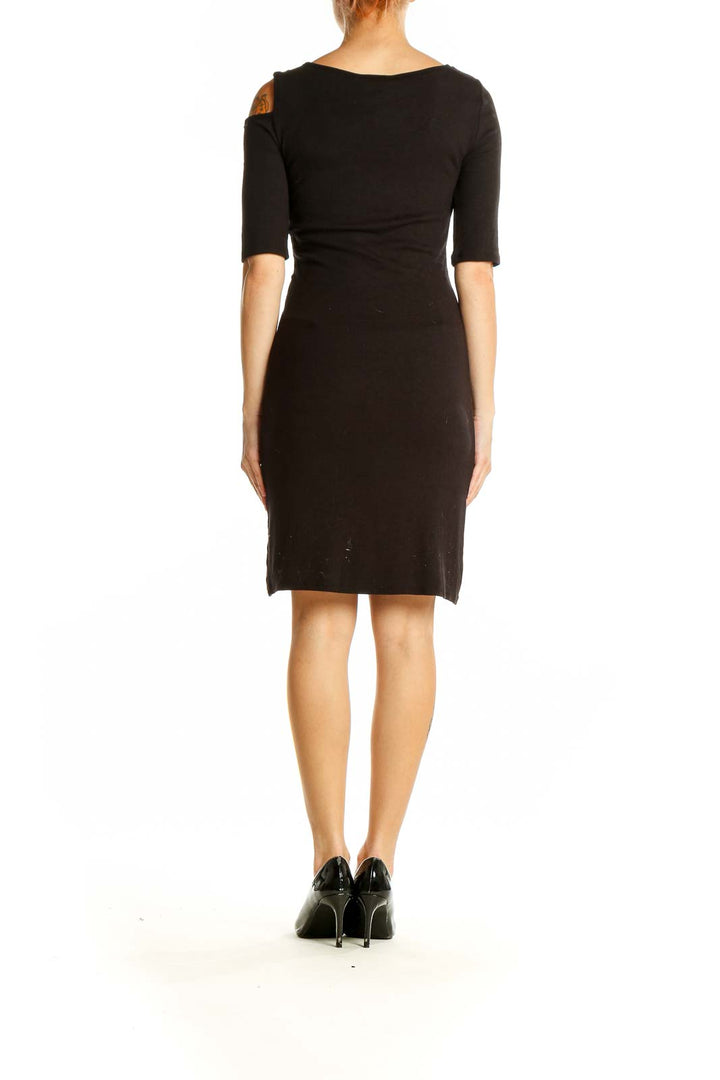 Side view of GOLDRAY black bodycon dress showing form-fitting silhouette