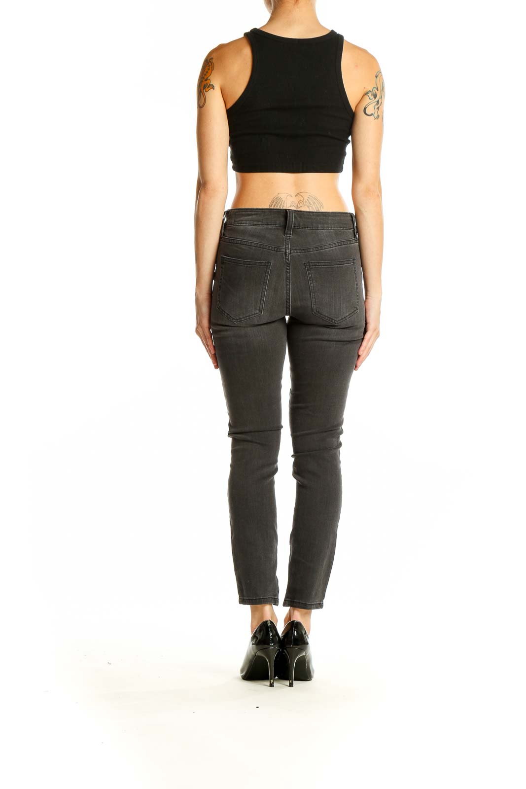 Side view of model wearing Pistola charcoal gray slim fit ankle jeans with black crop top