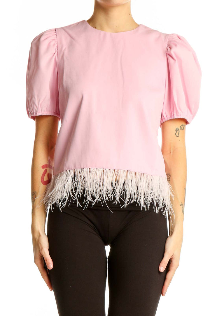 Front view of pink puff-sleeve top with feather trim by English Factory