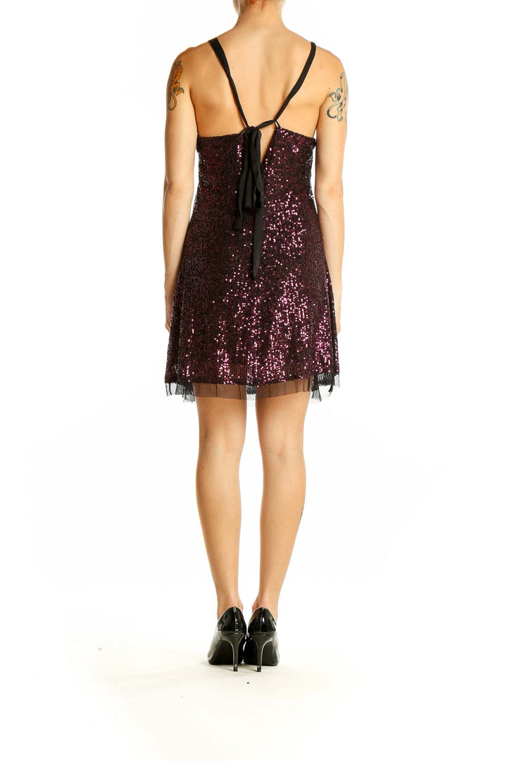 Side view of purple sequin mini dress showing body-hugging silhouette and tulle hem