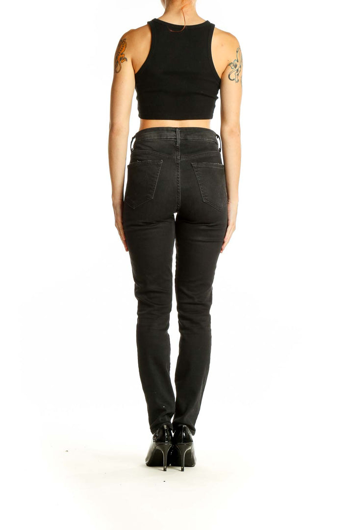 Back view of Mother black distressed straight leg jeans on model