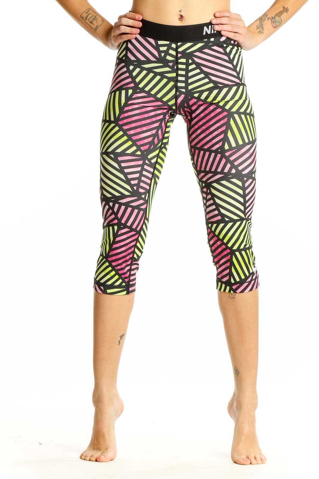 Front view of Nike Pro geometric print capri leggings in pink, yellow, and black