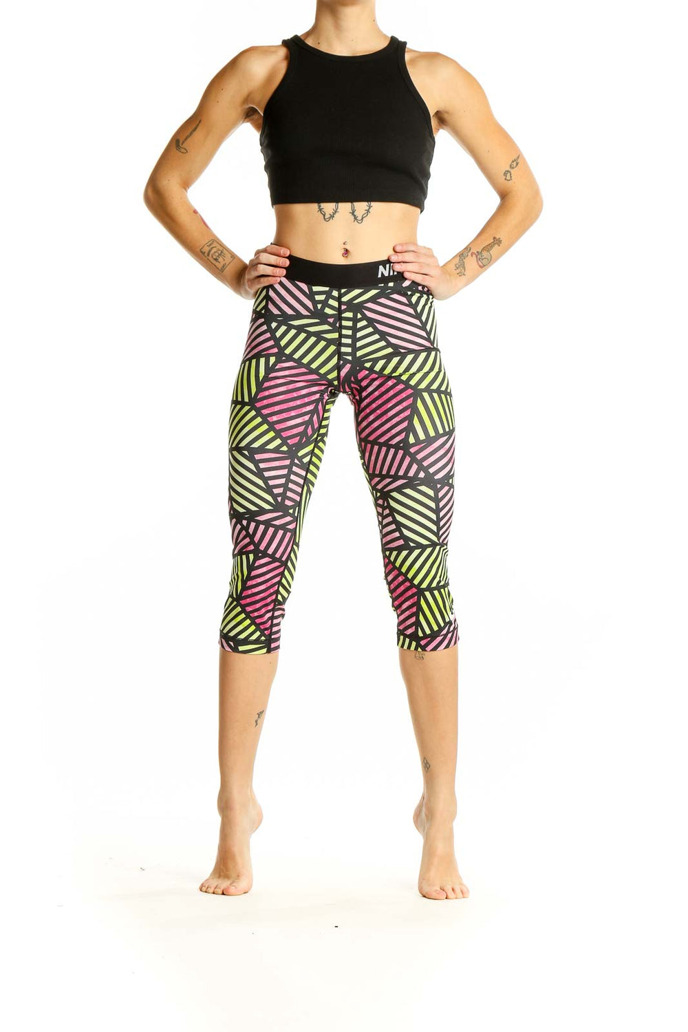 Front view of Nike Pro geometric print capri leggings in pink, yellow, and black