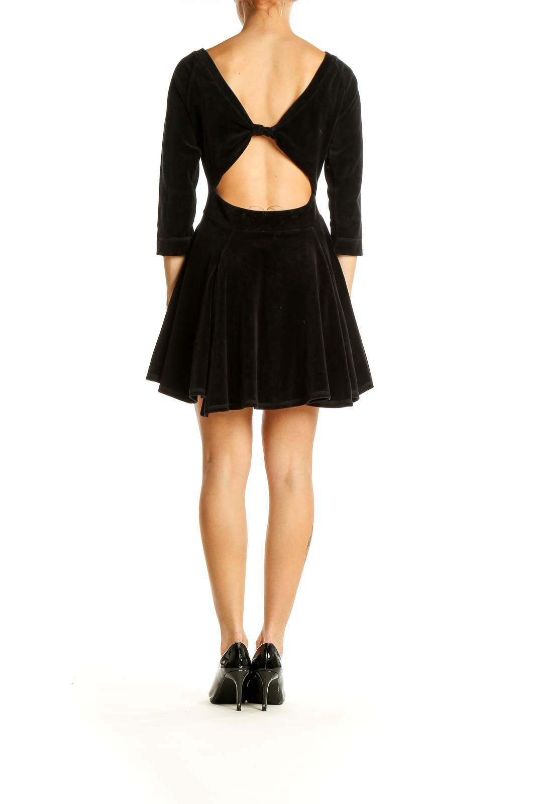 Back view of Aiko black velvet fit-and-flare mini dress showing flared skirt