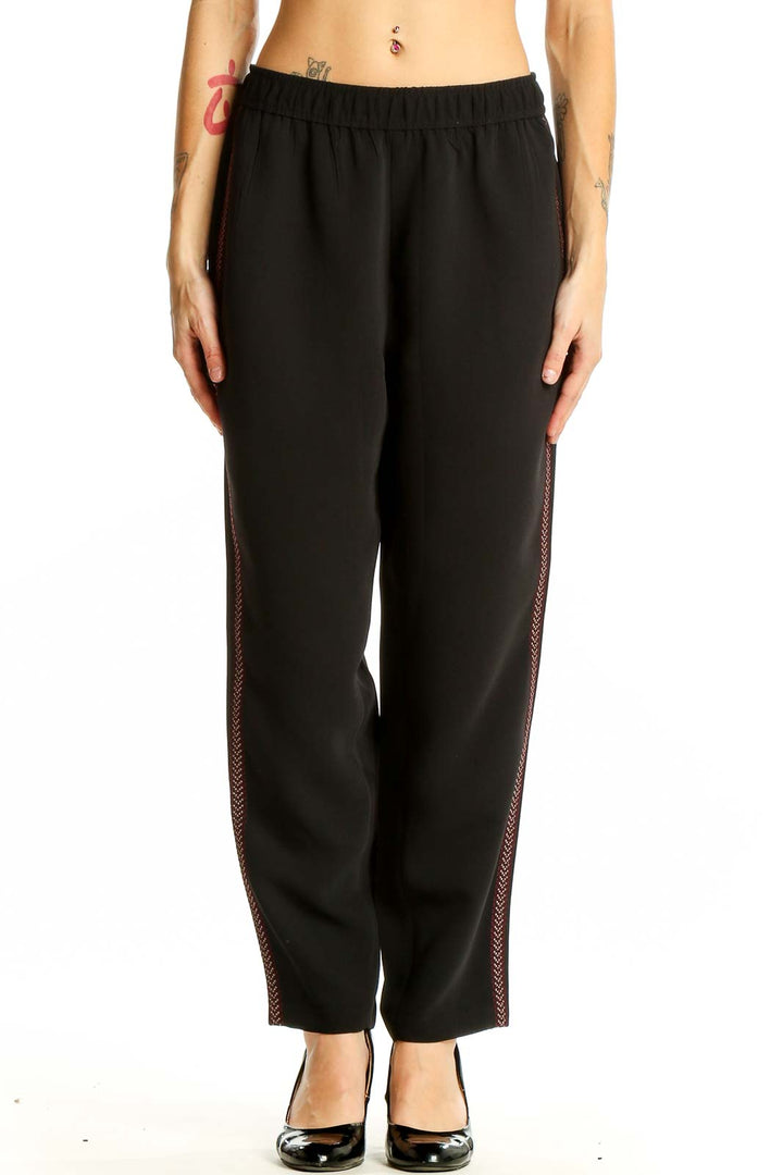 Front view of Madewell black polyester pants with side stripe