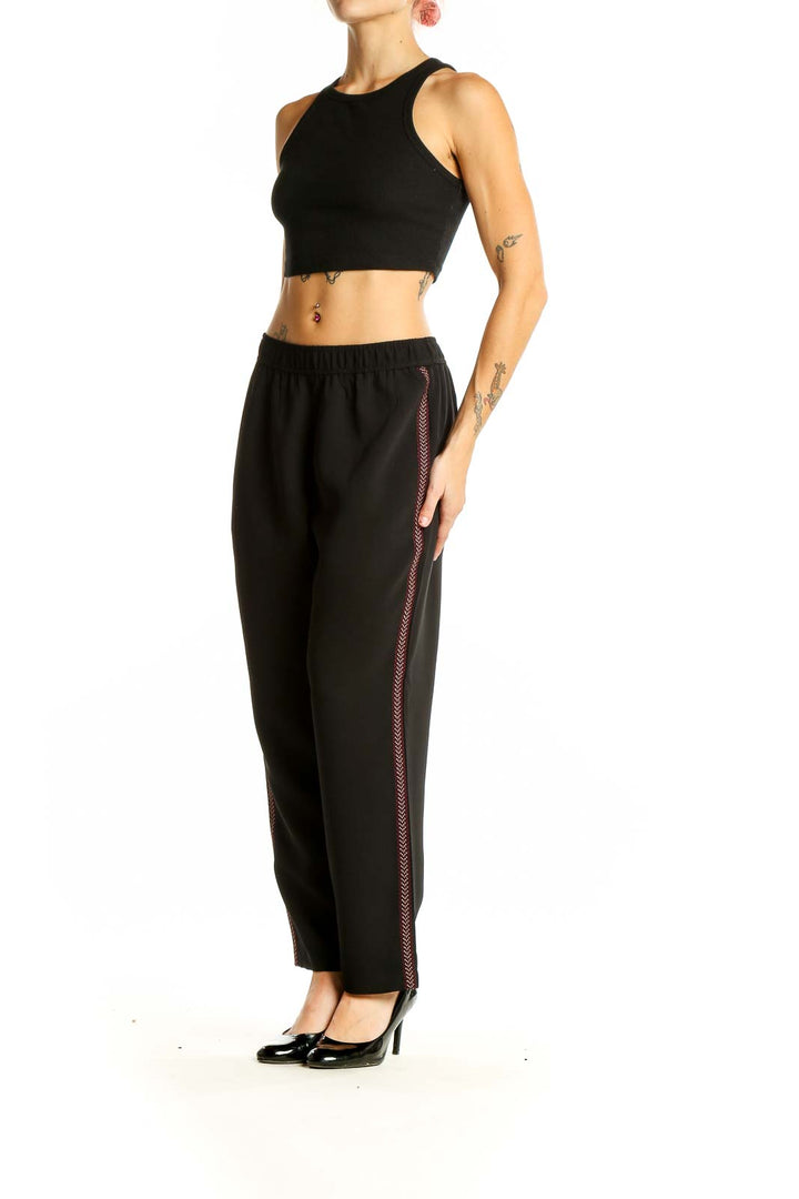 Front view of Madewell black polyester pants with side stripe