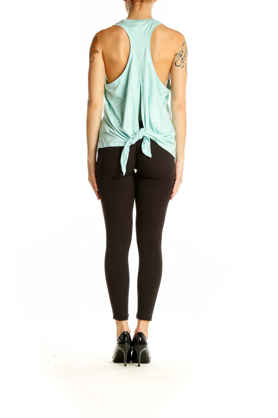 Side view of model wearing mint green Yogalicious tank top with black leggings