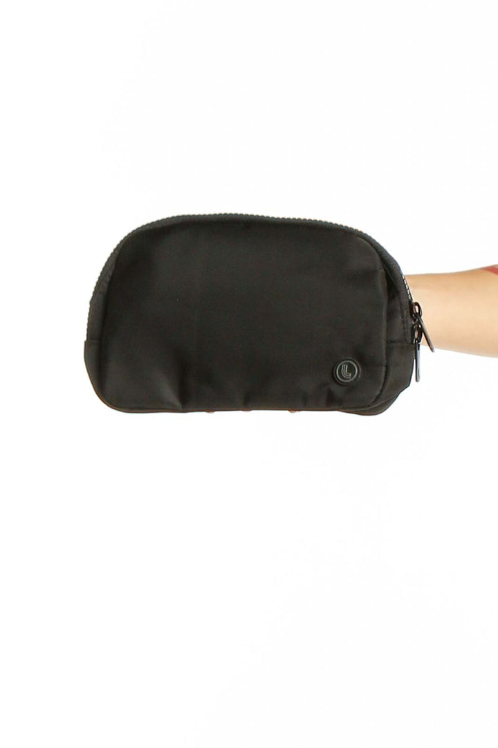 Front view of black LOLE nylon crossbody bag