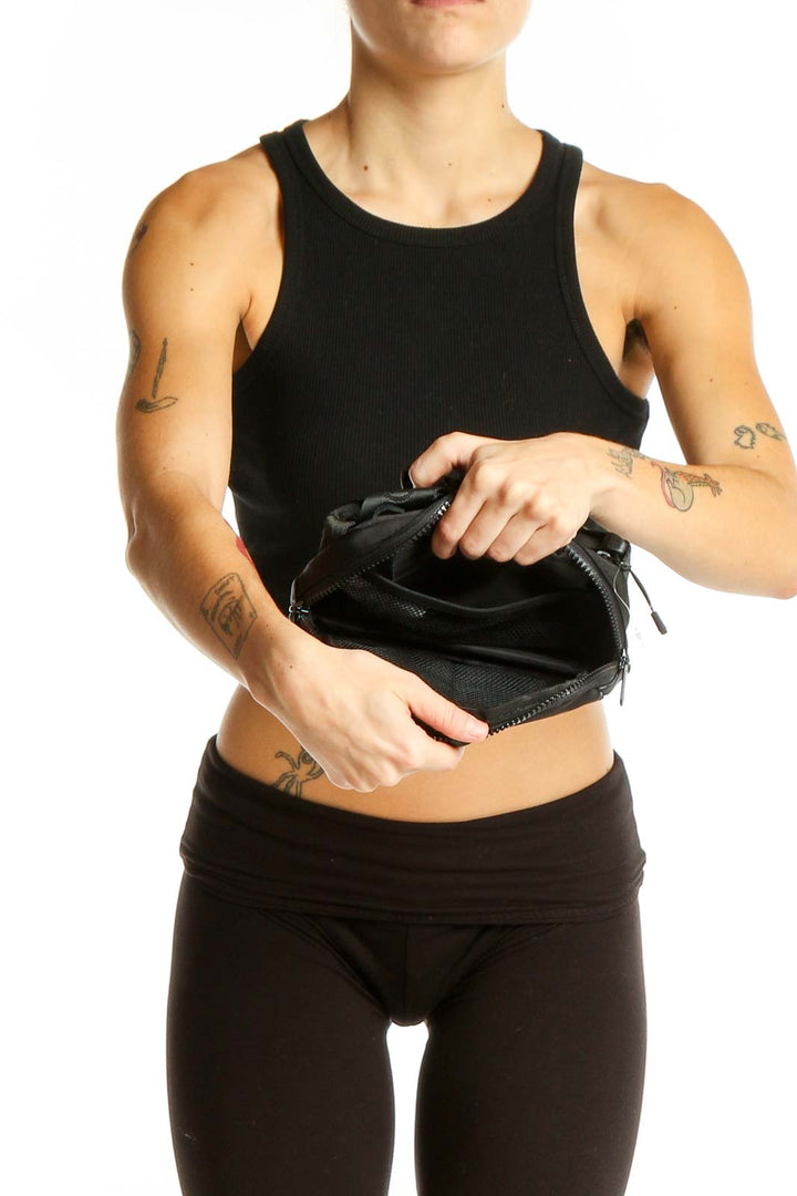 LOLE black crossbody bag worn by model with athletic wear