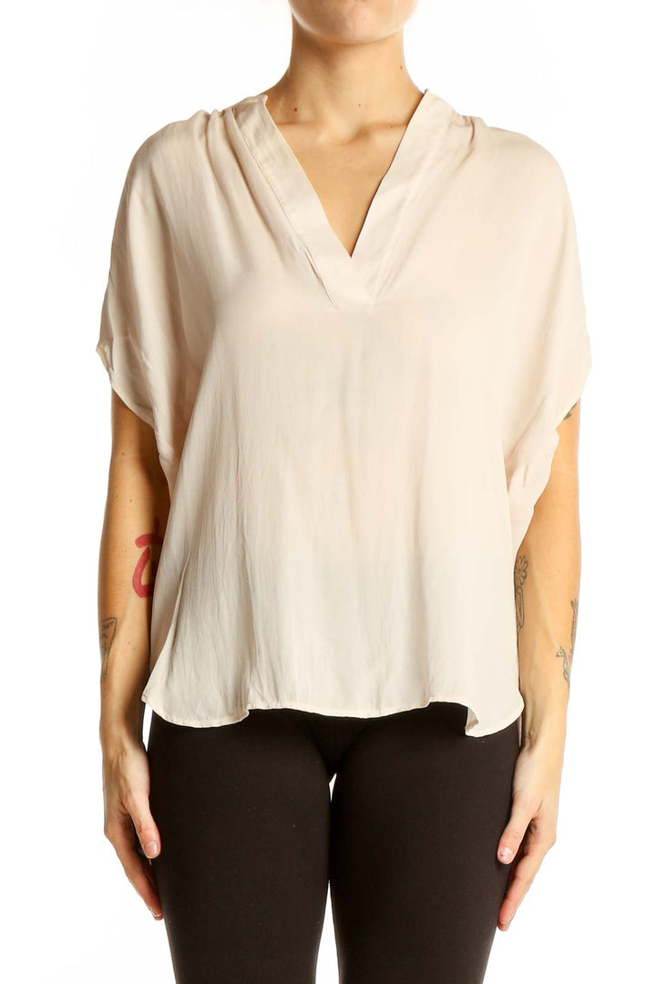 Front view of cream silk V-neck blouse by Vince