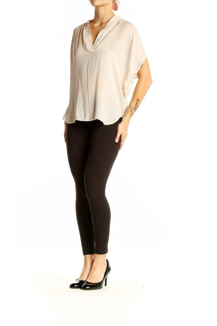 Front view of cream silk V-neck blouse by Vince