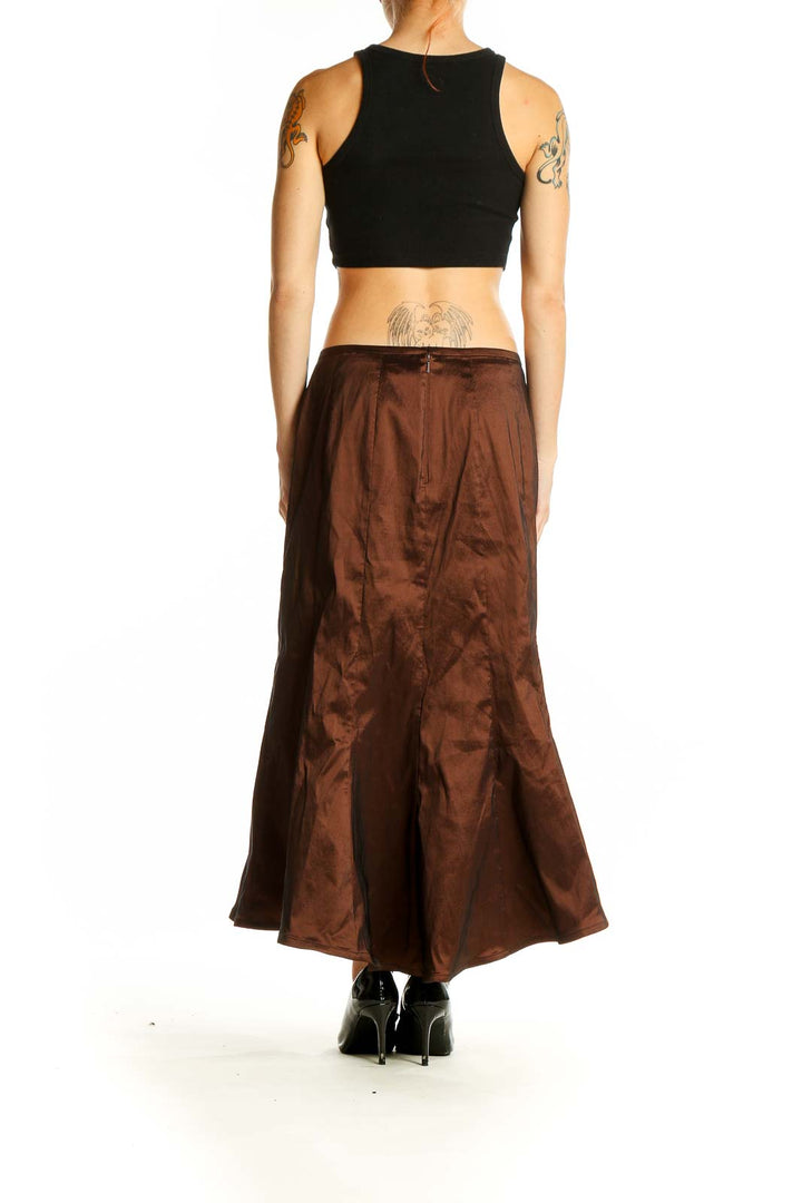 Side view of model wearing Tadashi brown satin mermaid maxi skirt with black crop top