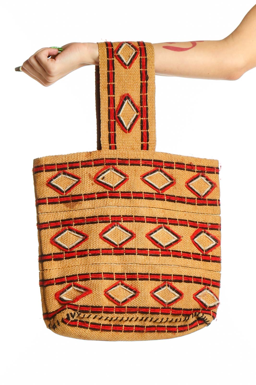 Front view of tan SilkRoll shoulder bag with red and orange geometric pattern