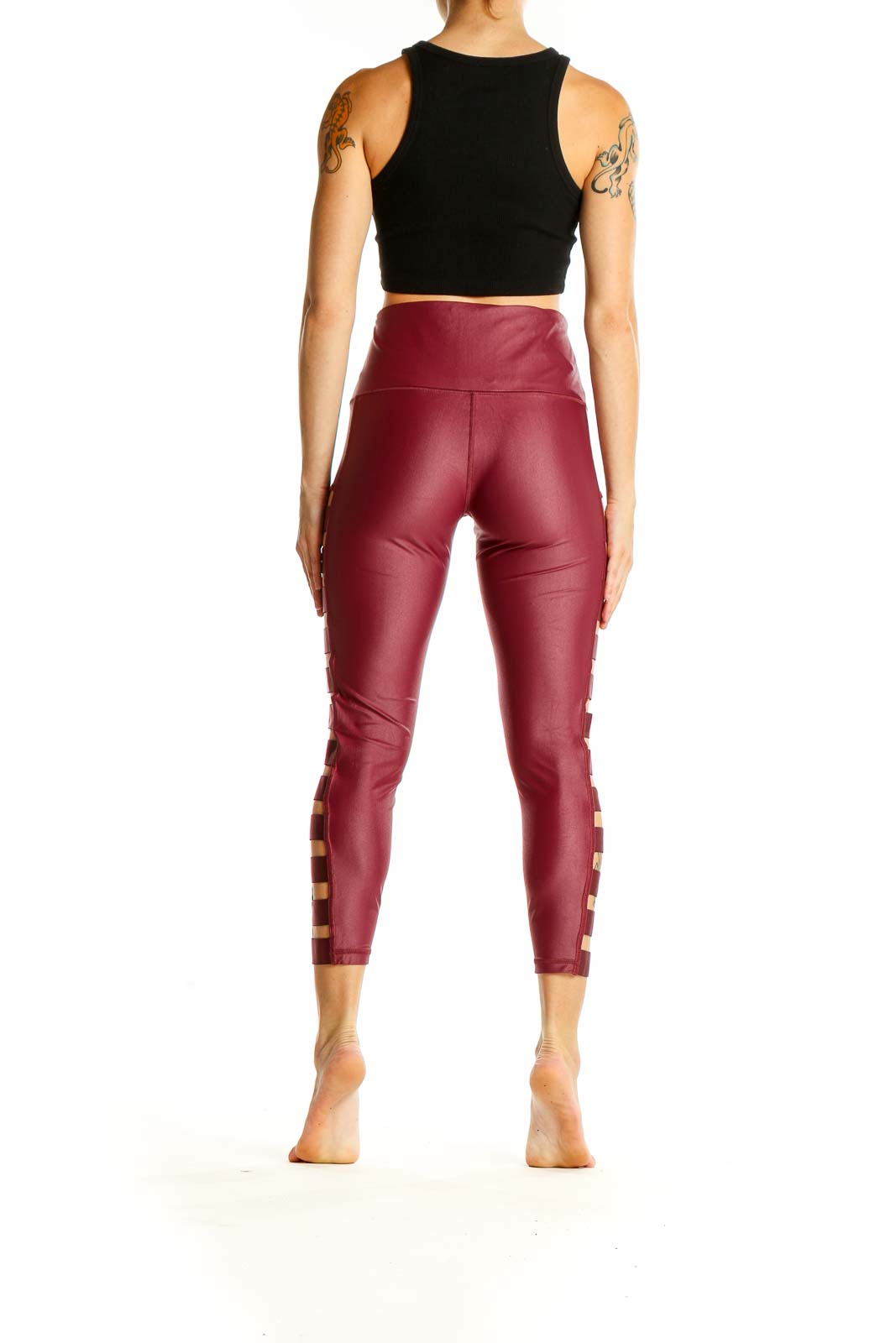 Side view of burgundy Victoria Sport high-waisted leggings showing cutout pattern