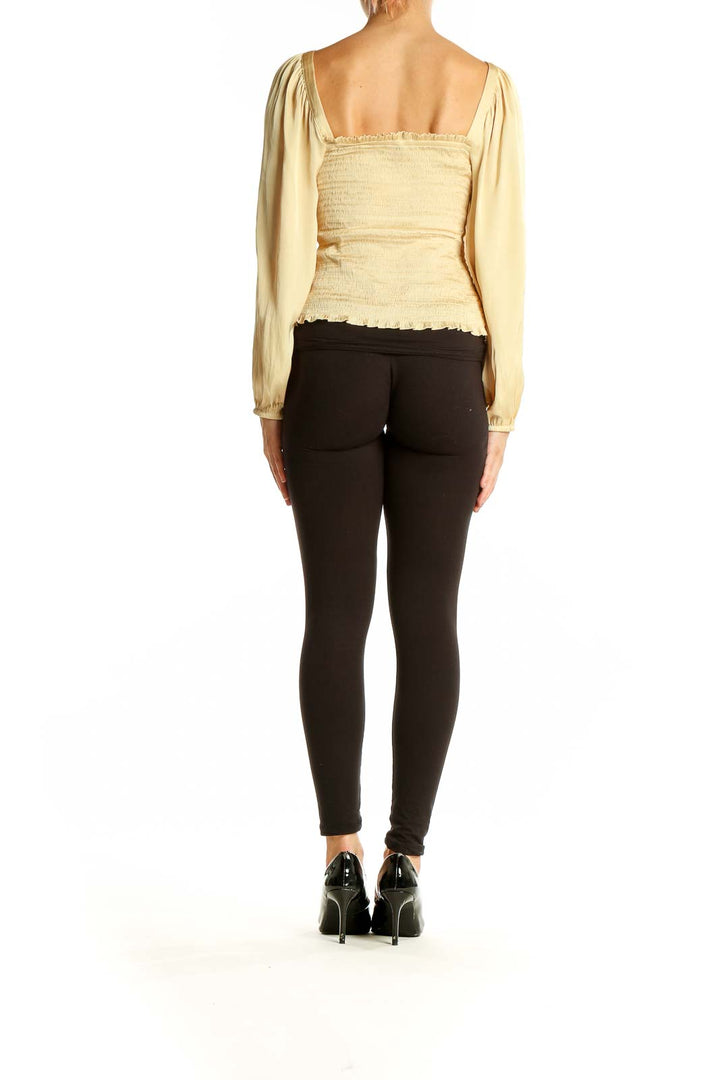 Back view of cream J.Crew blouse showing long sleeves and cropped length