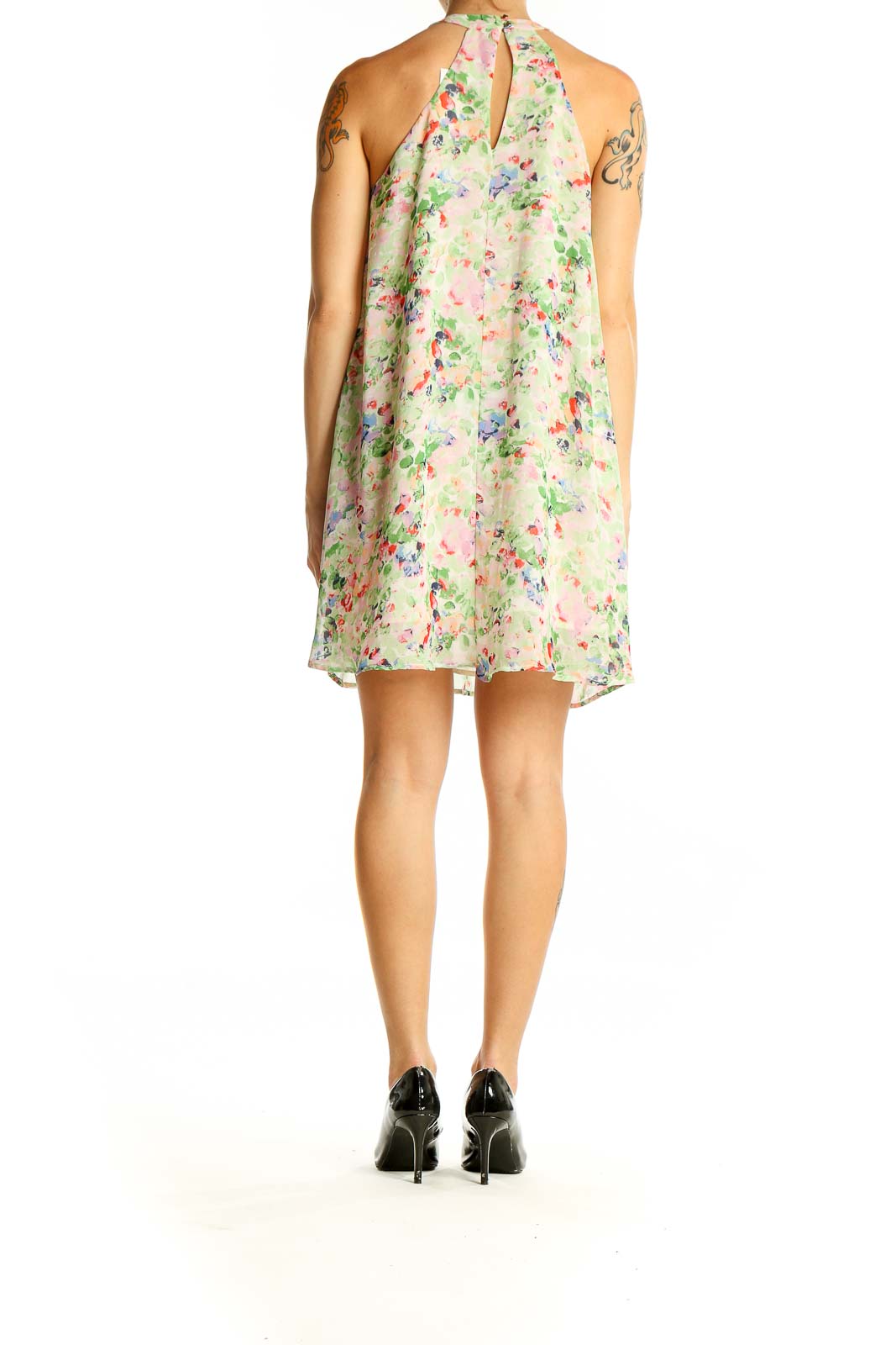 Side view of ASTR pastel floral halter neck mini dress showing flowy silhouette