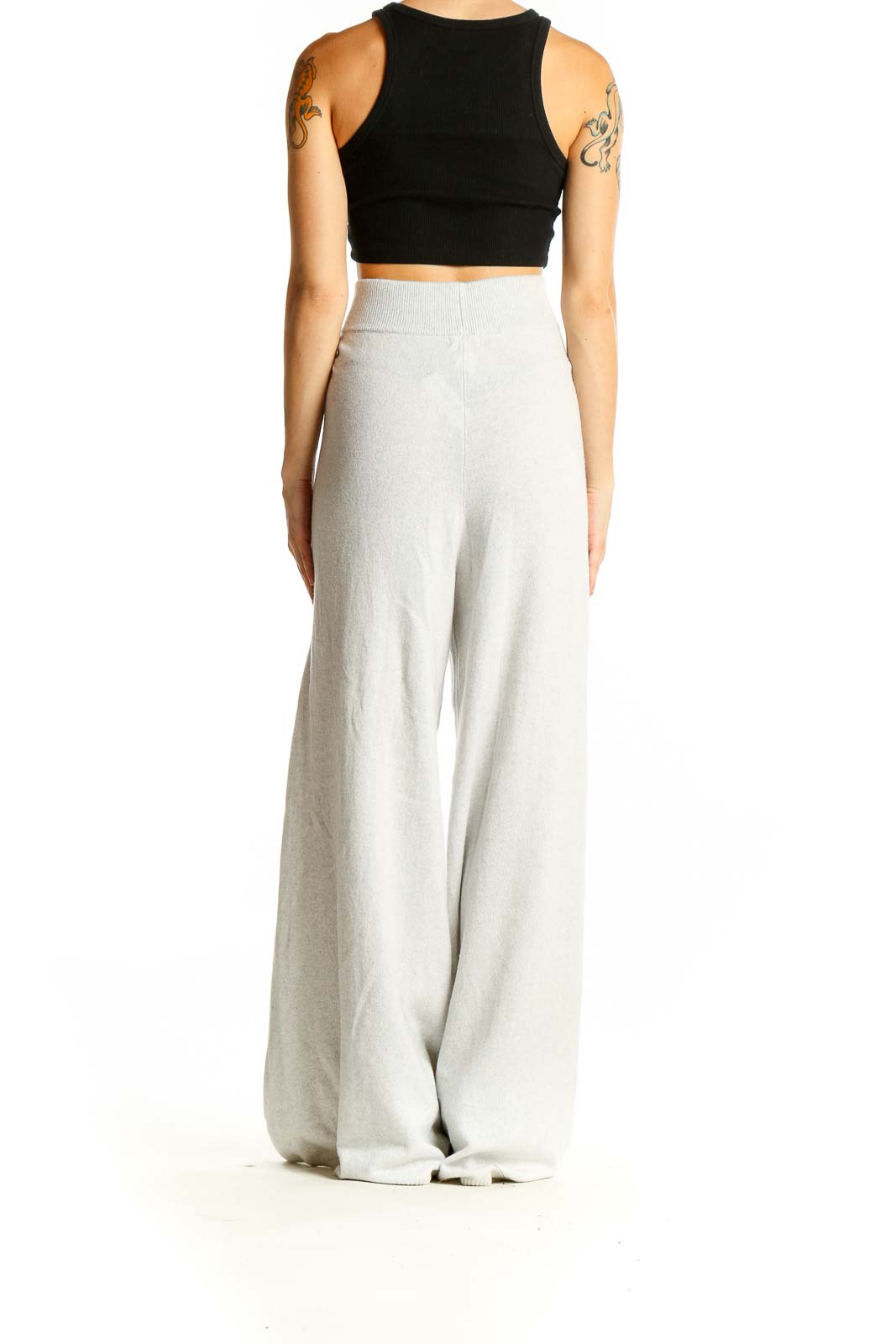 Side view of model wearing Leset light gray cashmere blend wide-leg pants with black crop top