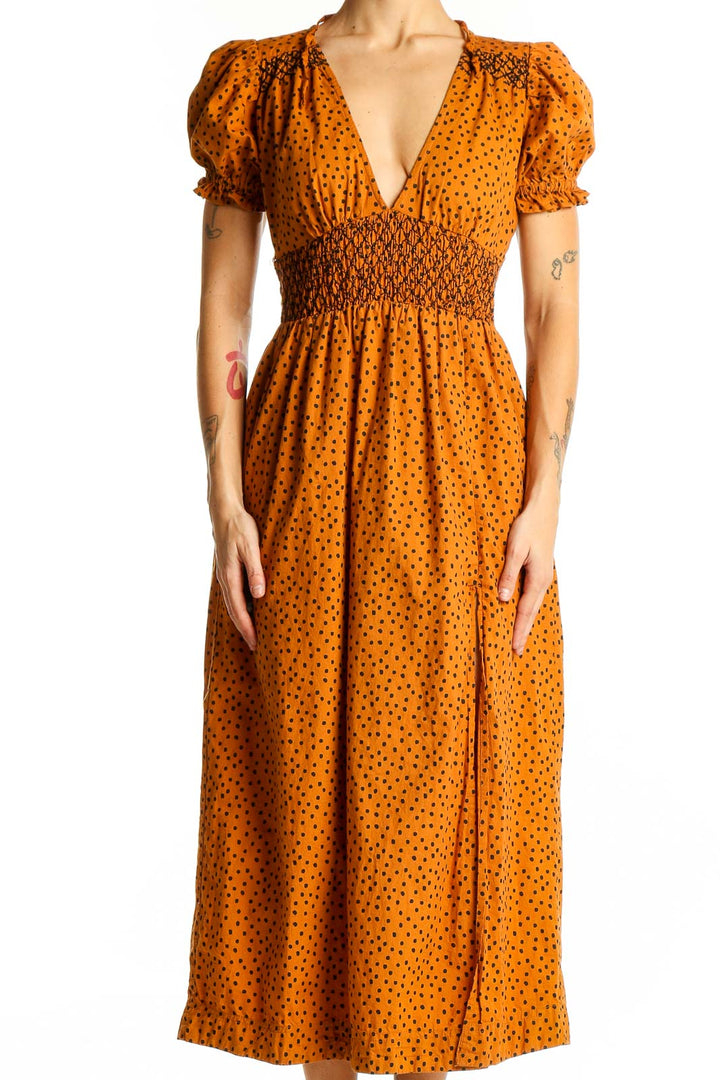 Front view of Urban Outfitters orange polka dot midi dress with puff sleeves