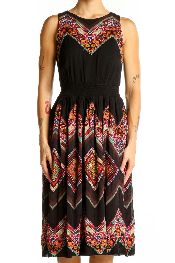 Front view of Tanvi Kedia black midi dress with colorful floral embroidery