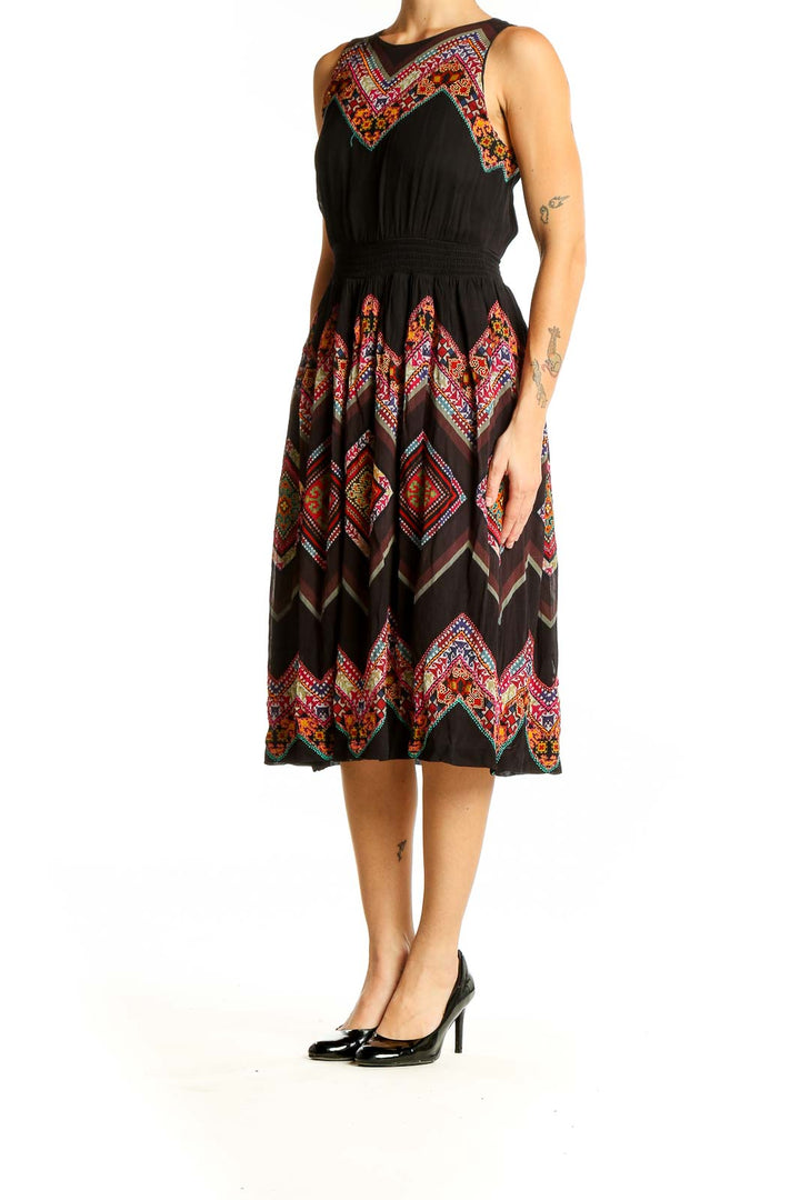 Front view of Tanvi Kedia black midi dress with colorful floral embroidery