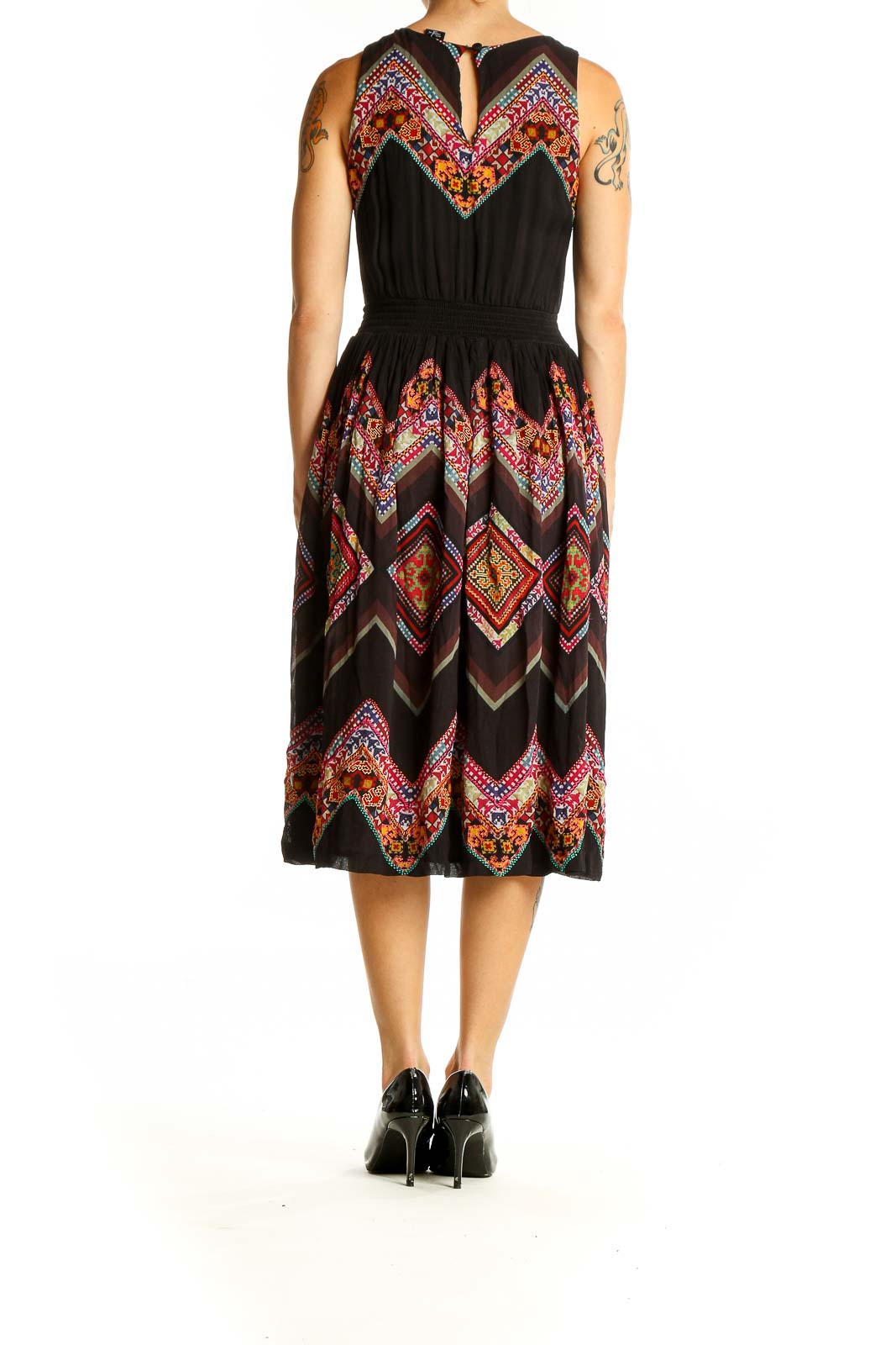 Back view of Tanvi Kedia black midi dress showing flared skirt with chevron pattern